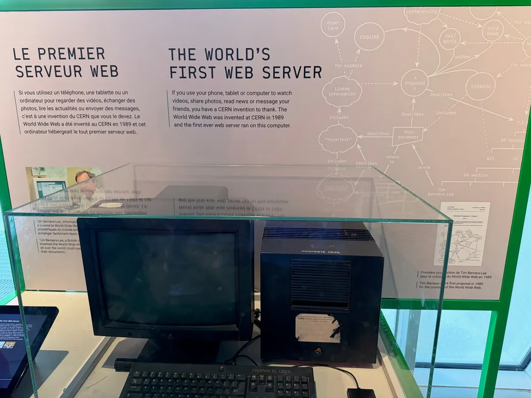 A computer on display beneath a sign reading The world's first web server at CERN