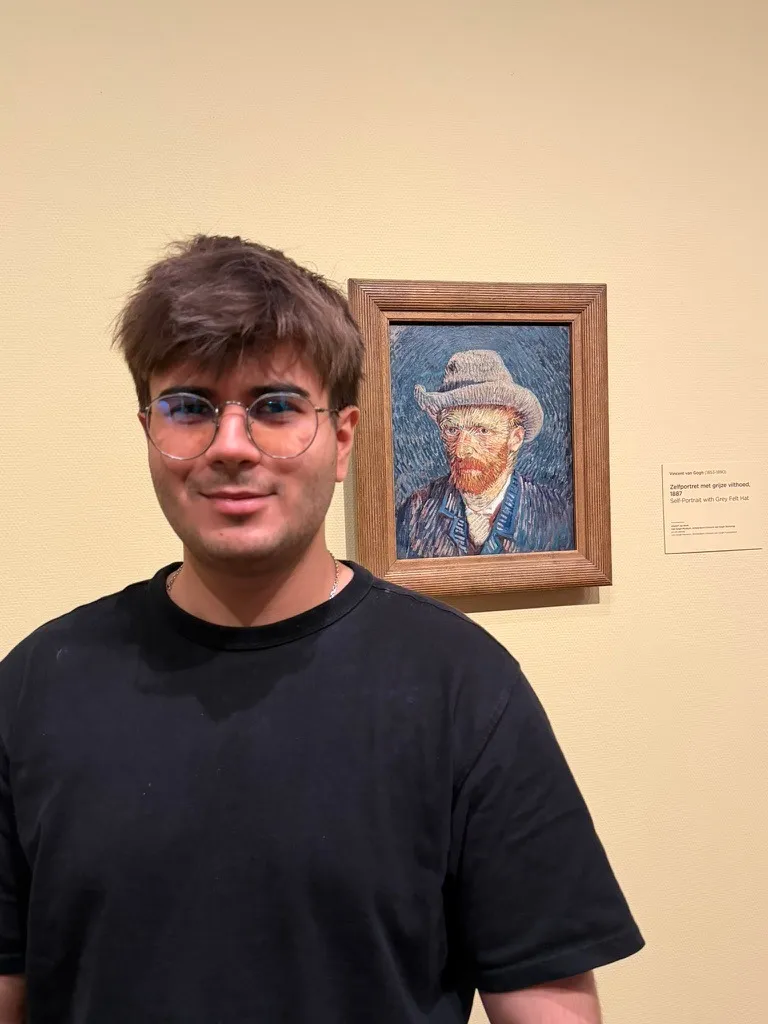 Maryan beside a Van Gogh self-portrait at the Van Gogh Museum in Amsterdam